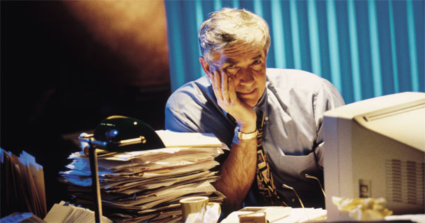 Overwhelmed Man at Desk