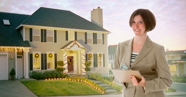 Woman with clipboard by decorated house