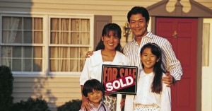Family with Sold Home Sign