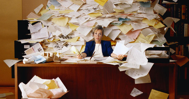 Woman Overwhelmed by Paperwork