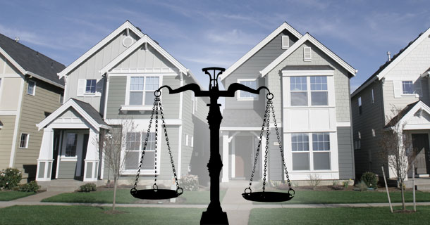 Scales of Justice in front of homes