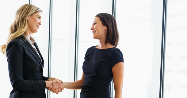 two women shaking hands