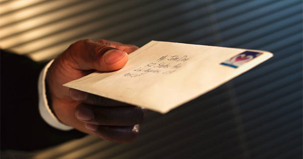 man holding mailed envelope