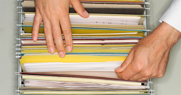 Man's hands and file folders