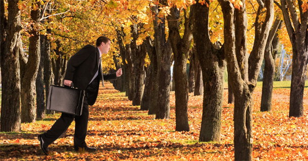 Man running thru autumn trees