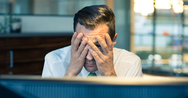 Man holding his head in his hands